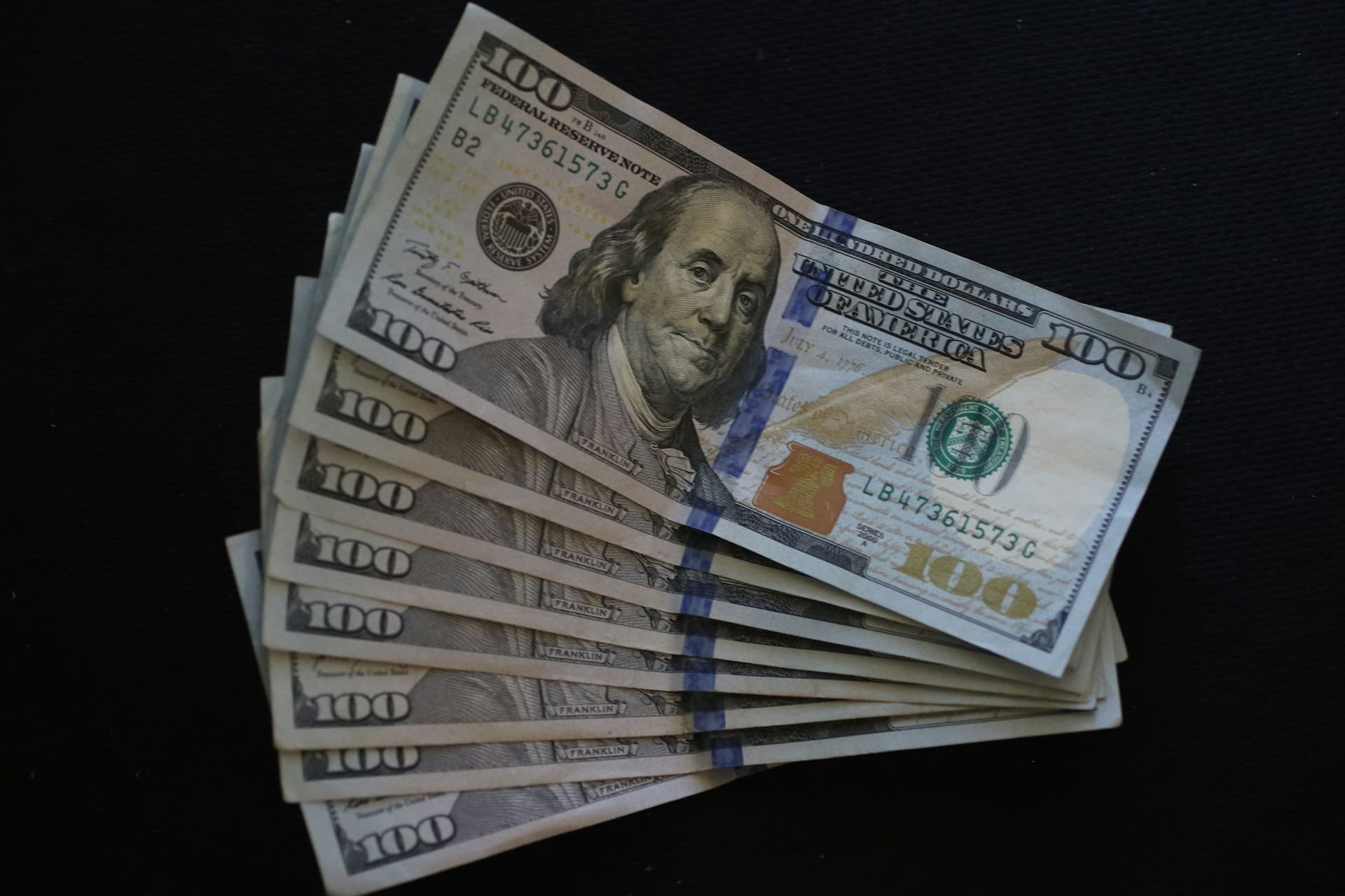 A scattered pile of US dollar bills